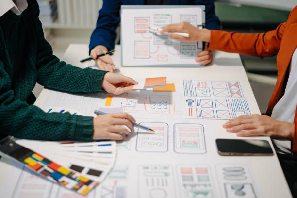 istock Close up view of UI developer team brainstorming on their project with laptop, smartphone and digital tablet. 2160199432