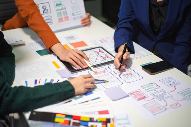 istock Close up view of UI developer team brainstorming on their project with laptop, smartphone and digital tablet. 2160199461