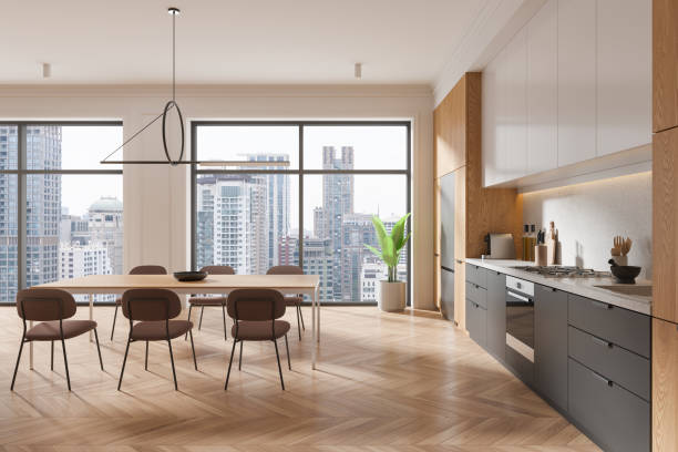 istock A modern kitchen interior with wooden elements and a dining area, set against a cityscape background, showcasing urban living. 3D Rendering 2160199899