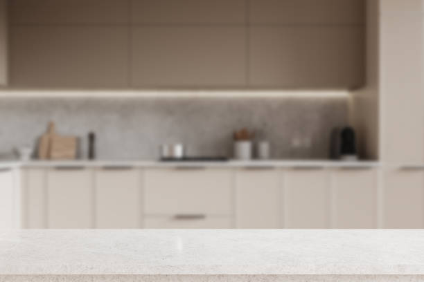 istock Gray and beige kitchen interior with cabinets and product display table 2160199988