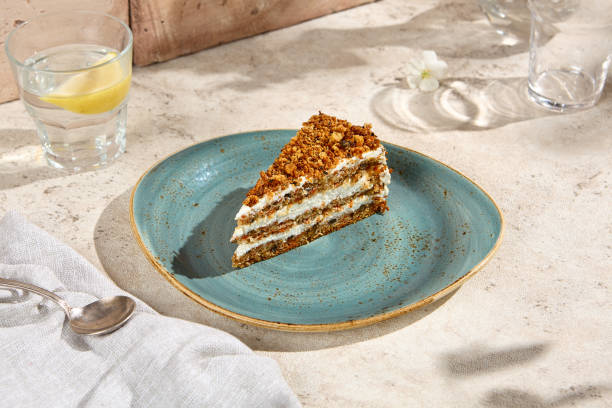 istock Authentic Carrot Cake Slice on Rustic Table with Natural Sunlight and Shadow Play 2160200040