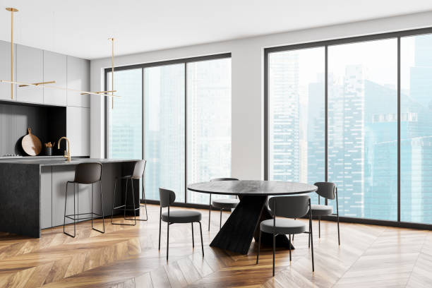 istock Stylish home kitchen interior with dining table and bar island with window 2160200087