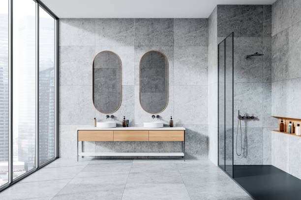 istock Modern bathroom with two mirrors and sinks, minimalistic style, large windows showing city buildings, light atmosphere. 3D Rendering 2160200362