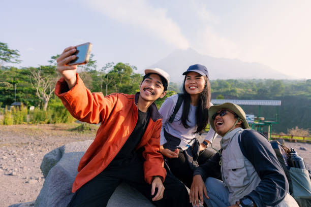 istock Three Friends Taking Selfie at Destination After Hiking with Backpack 2160201100