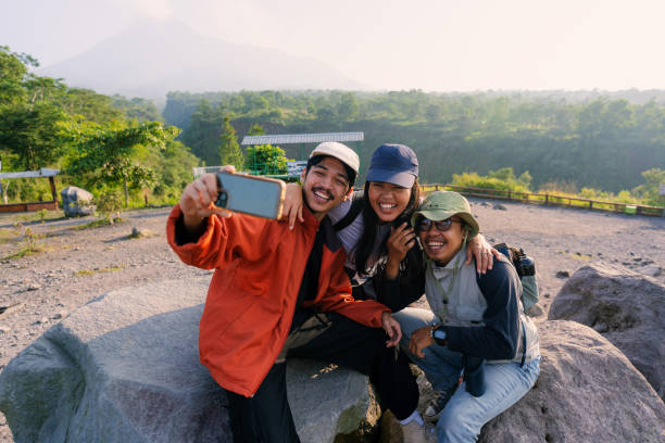 istock Three Friends Taking Selfie at Destination After Hiking with Backpack 2160201196