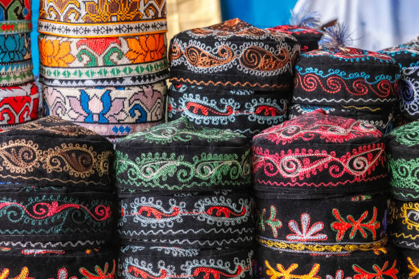 Tubeteika is traditional Central Asian cap. Tubeteikas are today worn in Tajikistan, Kazakhstan, Kyrgyzstan, and Uzbekistan, as well as in Muslim-populated regions of Russia (mainly Tatars) and Azerbaijan. The skullcap worn by Uzbeks and Uyghurs is called a doppa and has a square base. Tubeteikas are worn typically by the Turkic ethnic groups of the region. Image has been captured in an outdoor traditional public bazaar in Semerkand, Uzbekistan.