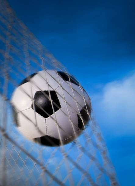 Young boy running after a soccer ball