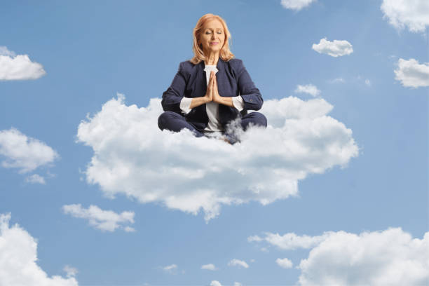 istock Businesswoman on a cloud and practicing meditation 2160202630
