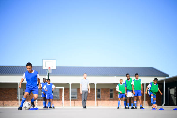 Wide angle view of school children practising soccer drills
