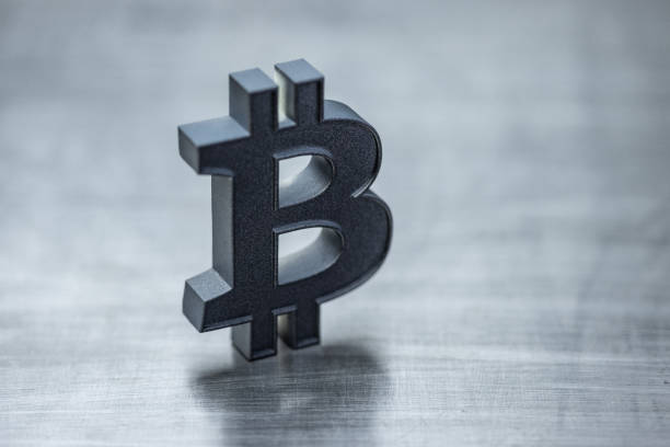istock Digital wallets and crypto currency concept. Digital money and blockchain technology. Titanium bitcoin icon on steel background. Minimalistic setup with copy space. Elements painted with dark graphite metallic paint. 2160204597