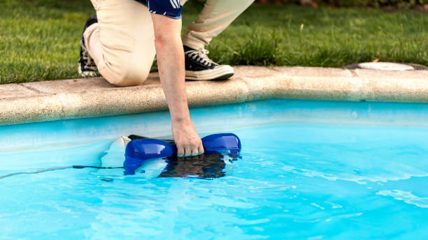 istock Pool maintenance. Taking out robotic pool cleaner. Robotic  vacuum cleaner 2160206765