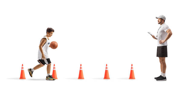Coach training basketball with a teenage boy isolated on white background