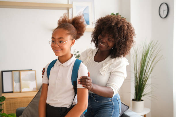 istock Mother getting her daughter ready for school at home 2160207891