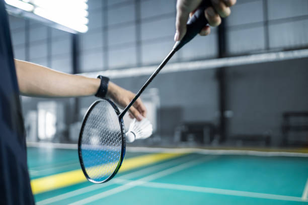 istock Badminton serving forehand position with racket and shuttlecock, competitive racket sport activity and leisure and competitiveness concept copyspace. 2160208015