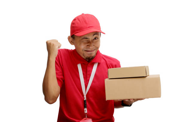 istock Asian Delivery Man Celebrating with YES Gesture and Cardboard Box 2160208409