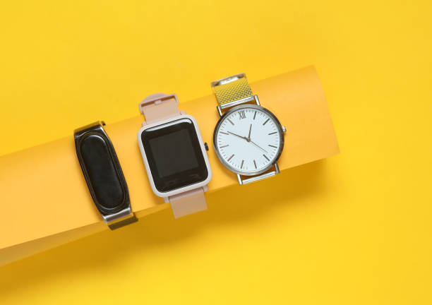 istock Modern smart and analog watches and bracelet on a yellow background. 2160208423