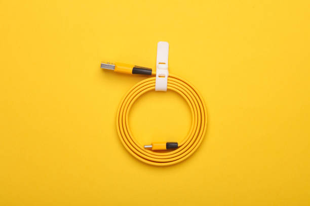 istock Yellow usb cable rolled up on a yellow background 2160209005