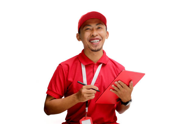 istock Confident Asian Delivery Man Checking Inventory with Tablet 2160209246