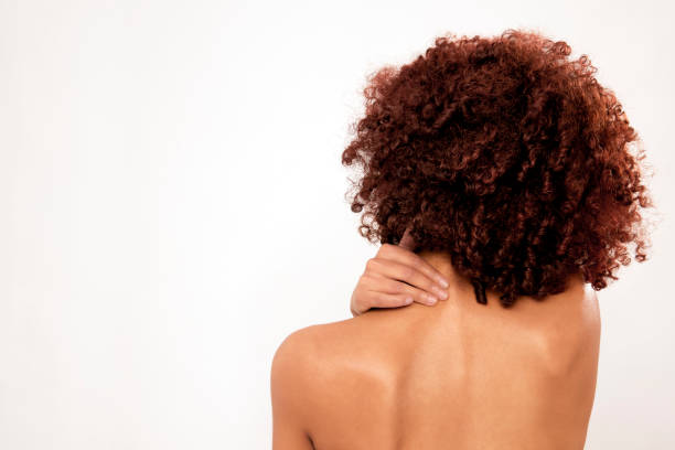 istock Rear view of a womans back touching her neck 2160209272