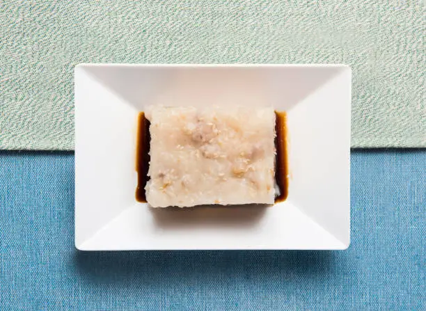Whole carrot cake dim sum served in dish isolated on napkin top view of chinese food Whole carrot cake dim sum served in dish isolated on napkin top view of chinese food