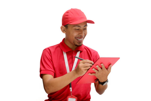 istock Confident Asian Delivery Man Checking Inventory with Tablet 2160209564