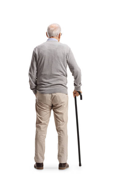Rear view shot of an elderly man standing with a cane