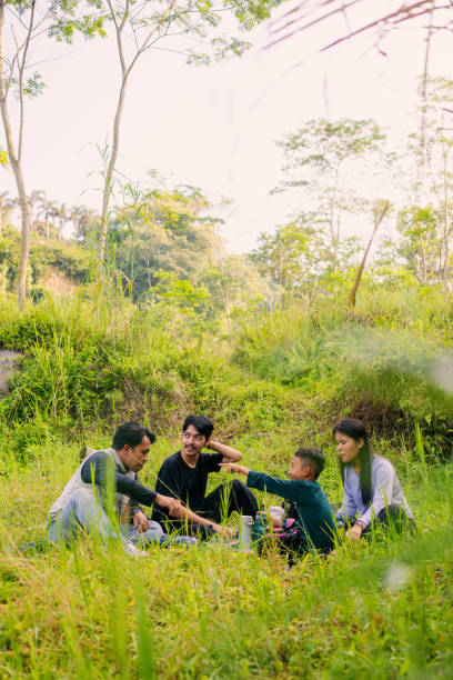 istock Group of Diverse Age Friends Having a Picnic on Grass 2160211427