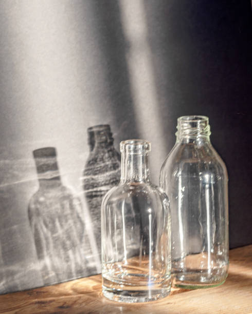 istock Still life with glass bottles, quiet shadows in the background, soft evening light 2160211863