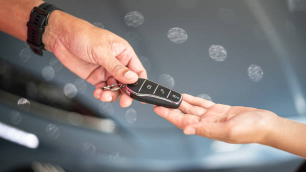 istock Buying a new car, taking the key. 2160215096