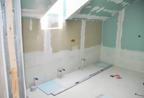Flush toilet, green hammer and green screwdriver to remove white cement from a toilet base. to replace or make repairs