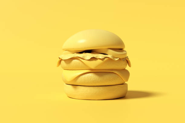 istock Yellow monochromatic cheeseburger standing on yellow background 2160216579