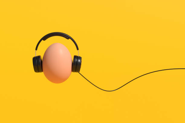 istock Egg listening music using headphones on yellow background 2160216993