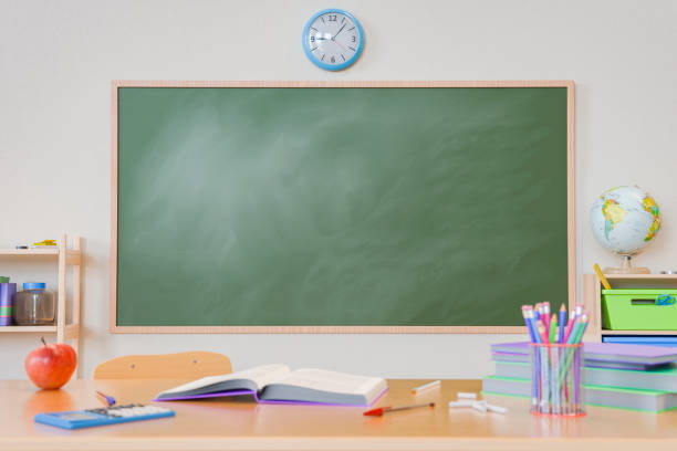 istock Empty Chalkboard and School Supplies in Classroom 2160217316