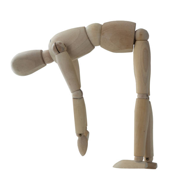 istock Jointed wooden figure posed as if bending over and lifting something 2160218782