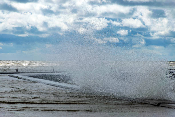 seascape, sea during a storm, splashing waves on the jetty, fast moving clouds, Cape Vente near the Curonian Spit in Lithuania