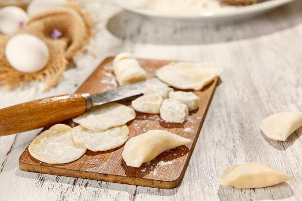 istock Rustic Cooking Scene with Eggs, Dough, and Flour on Wooden Board Amid Sunlight 2160222881