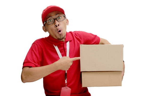 istock Asian Delivery Man Pointing at Cardboard Box Packages 2160223068