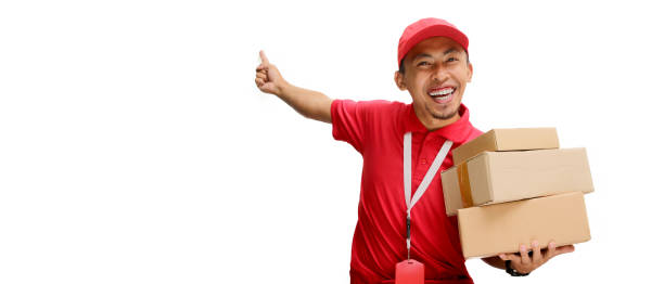 istock Asian Delivery Man Pointing with Cardboard Box 2160223505