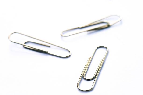 Metal clip. Office paper clip for important documents and files. Transparent white background, isolation.