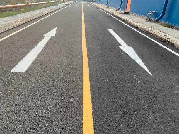 istock White Arrows on Asphalt Road 2160224641