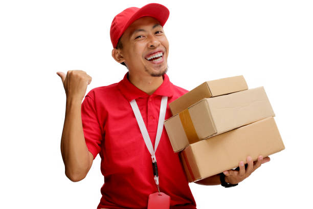 istock Asian Delivery Man Pointing with Cardboard Box 2160224809