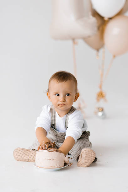 istock One year old boy eats his first birthday cake with his hands 2160225040