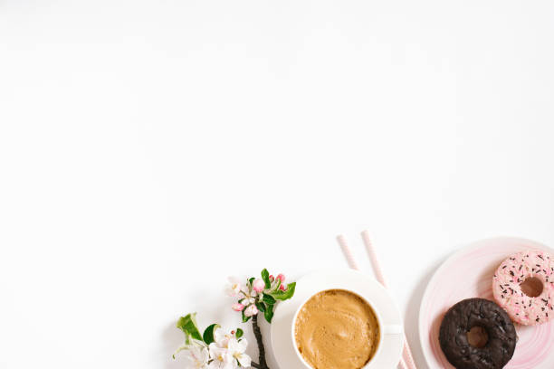 istock Stylish flat lay with cappuccino cup, apple blossoms, donuts on a white background with space copying. Morning breakfast or coffee break 2160225806