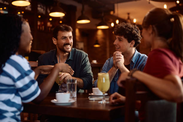 istock Happy man and his friends talking while enjoying in a cafe. 2160225937