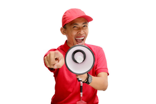 istock Excited Asian Delivery Man Pointing at Camera with Megaphone 2160226945