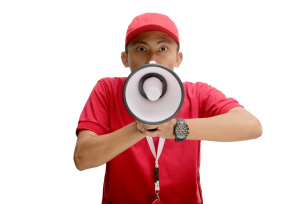 istock Surprised Asian Delivery Man in Red Uniform with Megaphone 2160227392
