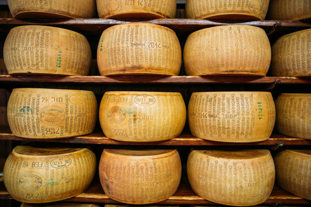 Parmesan is an Italian hard, granular cheese produced from cow's milk and aged at least 12 months or, outside the European Union, a locally produced imitation. The full, legally protected, name of the Italian cheese is Parmigiano Reggiano.