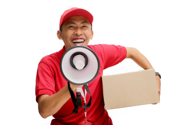 istock Asian Delivery Man Announcing Discounts with Megaphone 2160228126