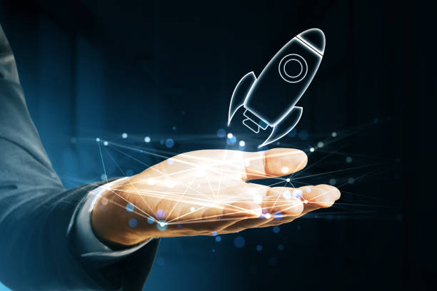 istock A person's hand with a holographic rocket projection, symbolizing startup and innovation concepts on a dark background 2160228476