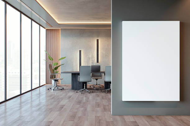 istock Modern office interior with large windows, an empty white poster on a gray wall, and contemporary furnishings, concept of workspace design. 3D Rendering 2160228715